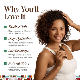 KREYÒL ESSENCE oil drop on fingers showing thick, moisturizing texture for hair benefit