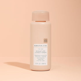 Kristin Ess conditioner applied to wet hair demonstrating detangling benefit