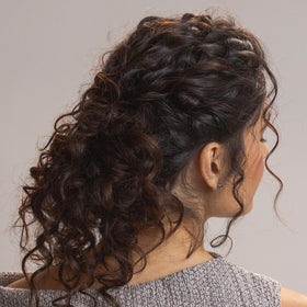 Kristin Ess before and after comparison showing reduced frizz and shinier curls