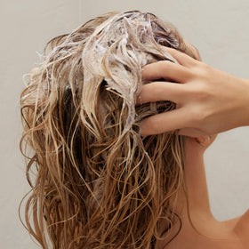 Kristin Ess before and after hair comparison showing reduced brass
