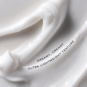 Kristin Ess distributing cream before blow-drying for smoother, shinier finish