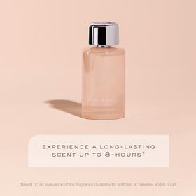 Kristin Ess bottle near pear and magnolia illustrating scent blend