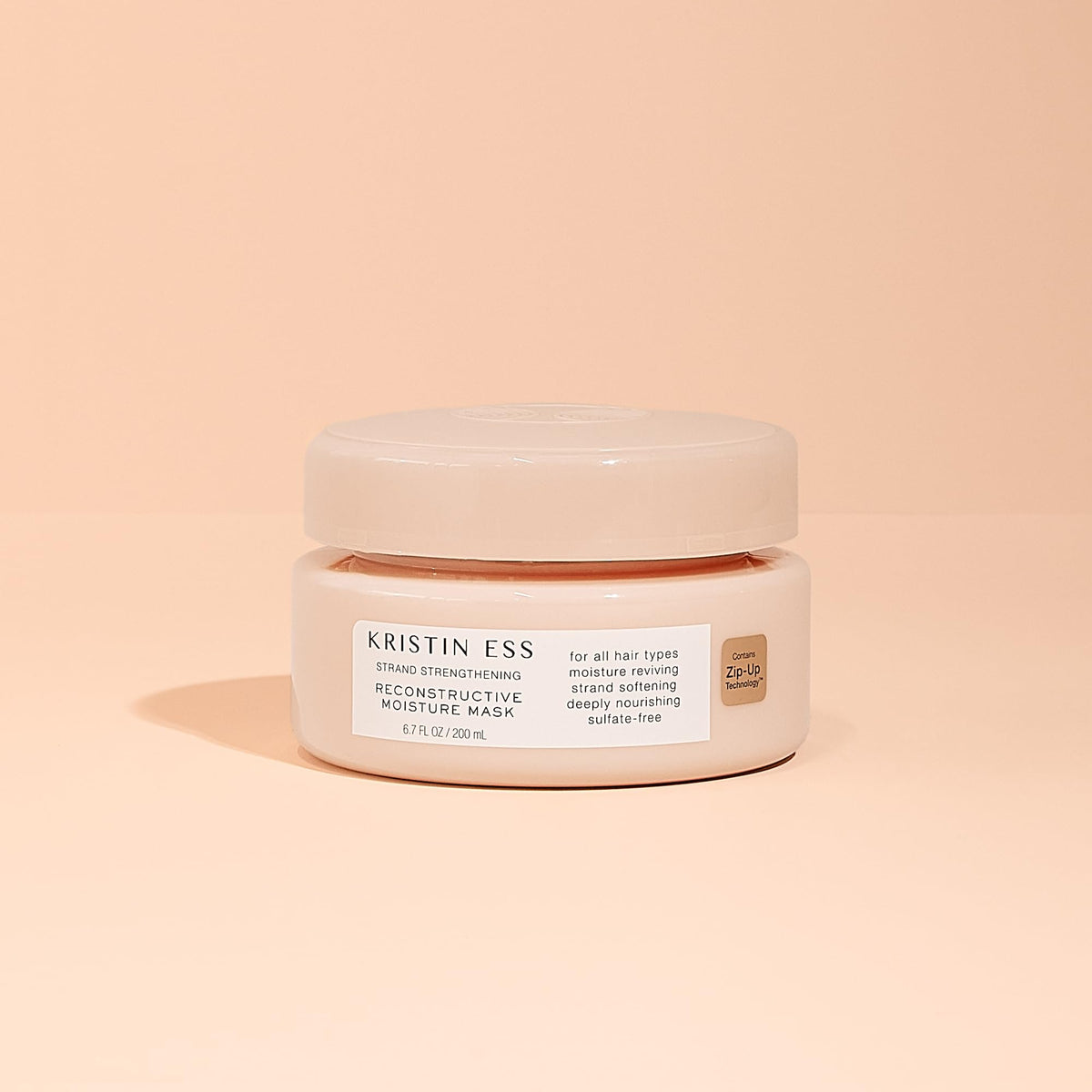 Kristin Ess lifestyle shot on bathroom shelf conveying salon-quality care at home
