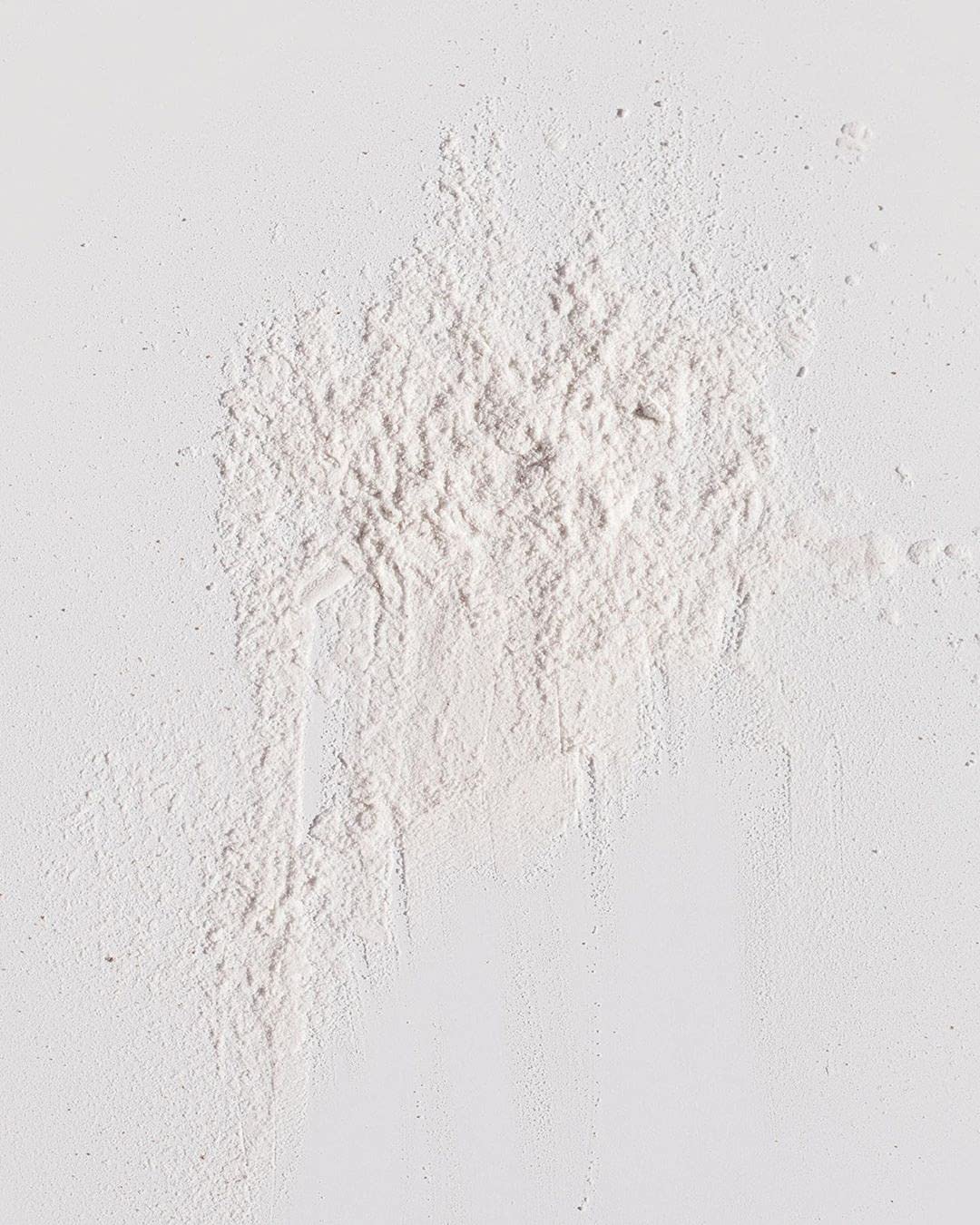 Kristin Ess open jar displaying fine powder texture for quick oil absorption