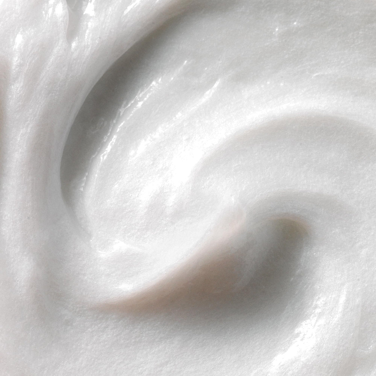 Kristin Ess close-up pour of conditioner texture showing rich slip for easier detangling