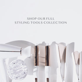 Kristin Ess curling iron held in hand to show scale and 2-inch barrel size