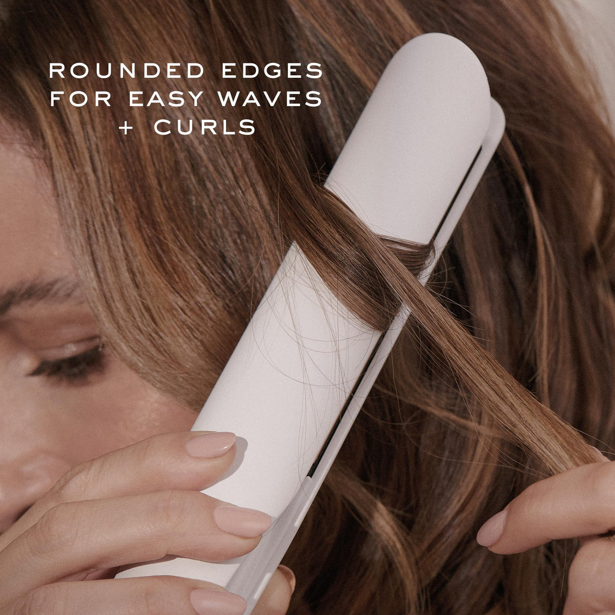 Kristin Ess styling tool in use curling hair to create long-lasting polished curls