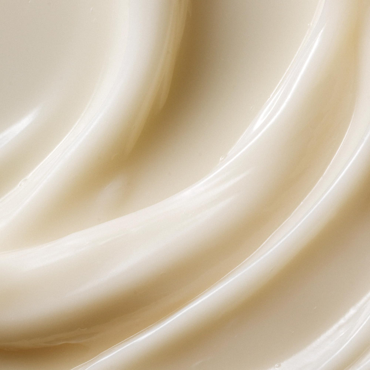 Kristin Ess conditioner texture close-up showing creamy consistency for smooth hair