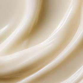 Kristin Ess conditioner texture close-up showing creamy consistency for smooth hair