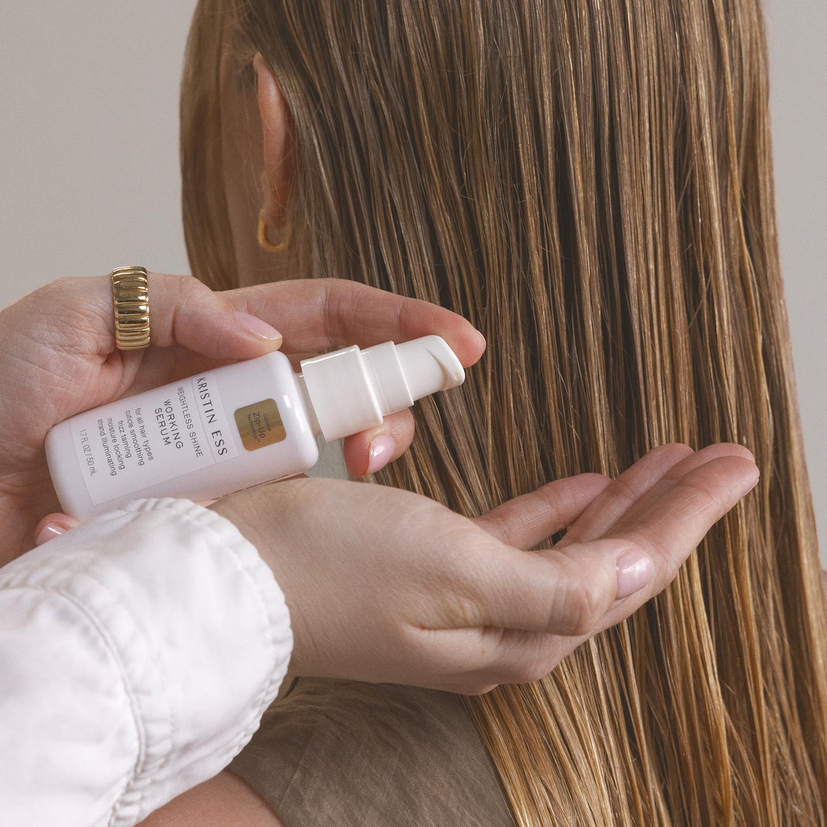 Kristin Ess working serum pump with droplet indicating lightweight shine