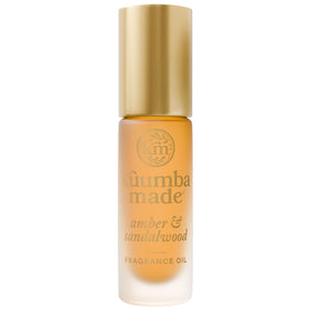 Kuumba Made front bottle view showing amber and sandalwood packaging benefit portable scent