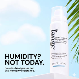 L'ANGE HAIR bottle in hand showing size and travelable convenience benefit