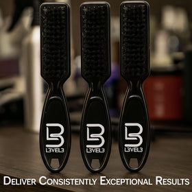 L3 brush in a barber hand in use delivering precise fades and clean lines