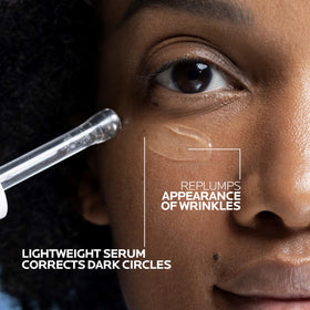 Applying La Roche-Posay Hyalu B5 Eye Serum onto hand before under-eye use for smooth glide