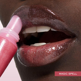 Lancôme Juicy Tubes next to common object for size comparison and travel-friendly benefit