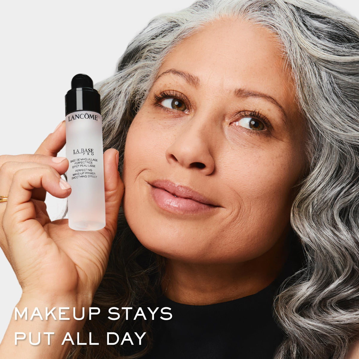 Lancôme primer held in hand to show true size and travel-friendly benefit