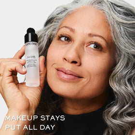 Lancôme primer held in hand to show true size and travel-friendly benefit