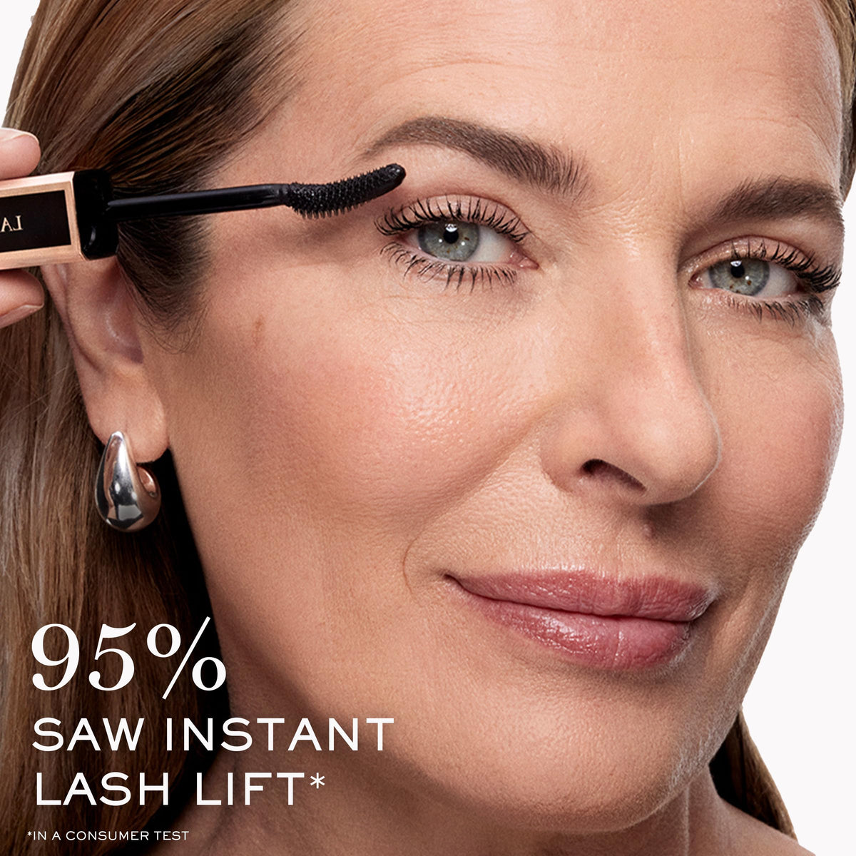 Lancôme model wearing mascara, lifestyle shot displays wide-open, defined eyes