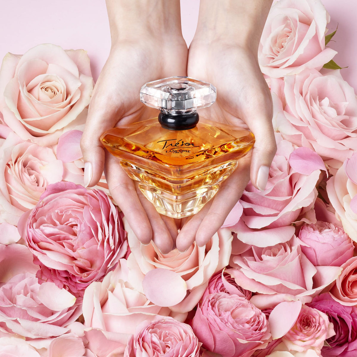 Lancôme Trésor golden-peach liquid in bottle highlighting radiant color