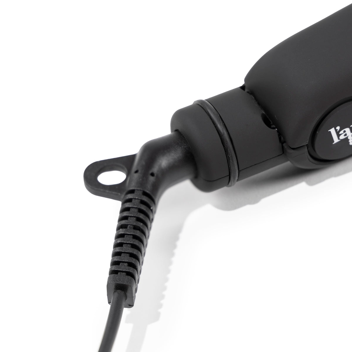 L'ANGE HAIR flat iron styling a model's hair, demonstrating frizz reduction and glossy results