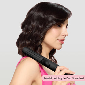Person holding L'ANGE HAIR styler demonstrating ergonomic grip and easy handling