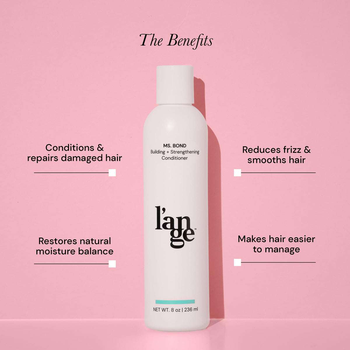 L'ANGE HAIR bottle in hand for scale conveying compact size and travel convenience