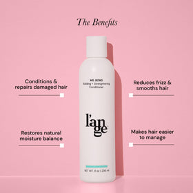 L'ANGE HAIR bottle in hand for scale conveying compact size and travel convenience