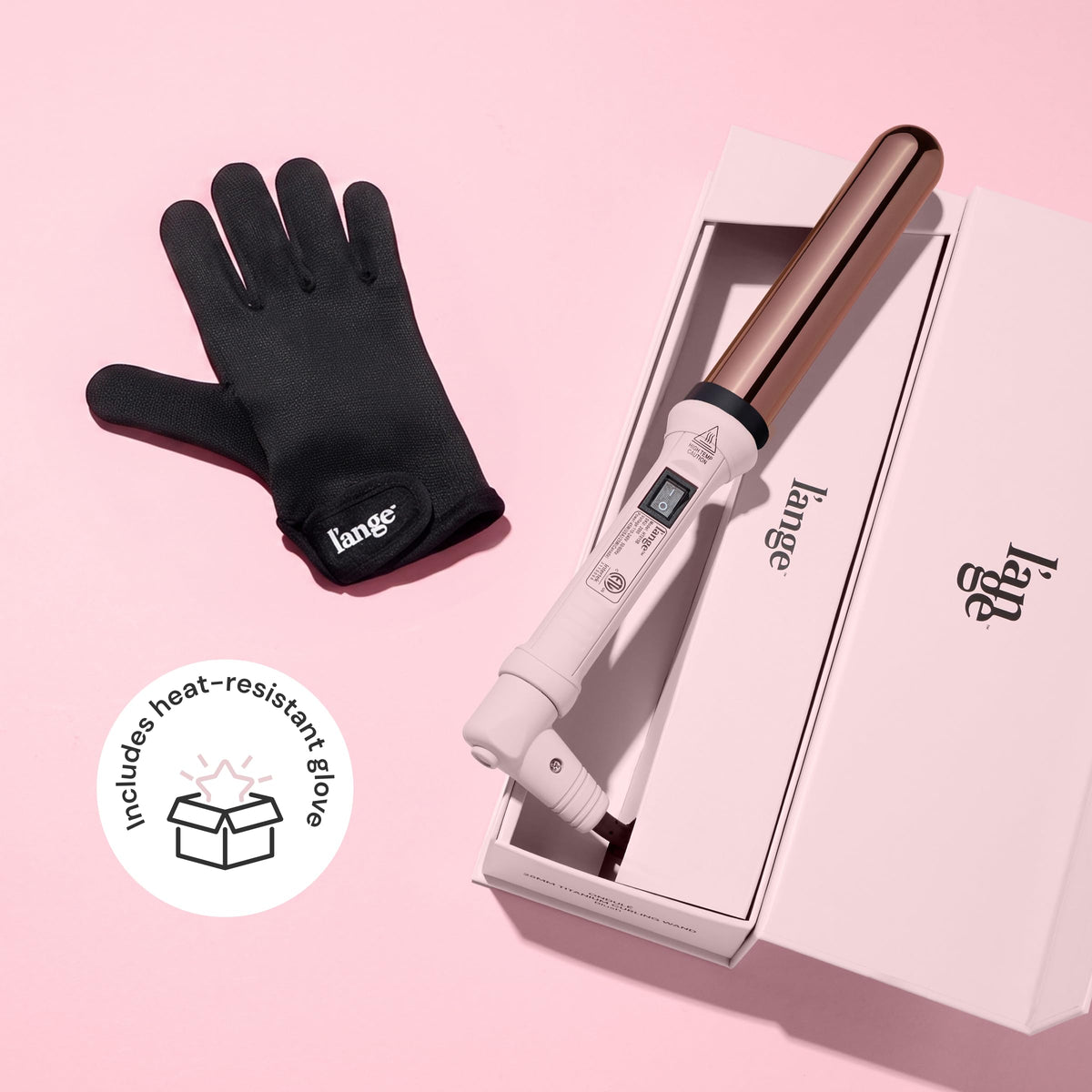 L'ANGE HAIR wand held in hand to show 1.25-inch size and ergonomic balance