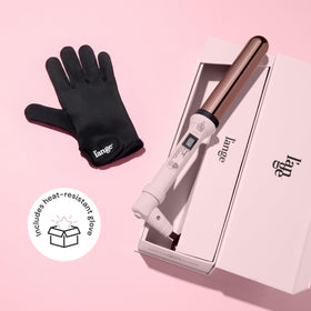L'ANGE HAIR wand held in hand to show 1.25-inch size and ergonomic balance