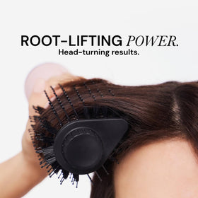L'ANGE HAIR tool held in hand to show size and portability for everyday use