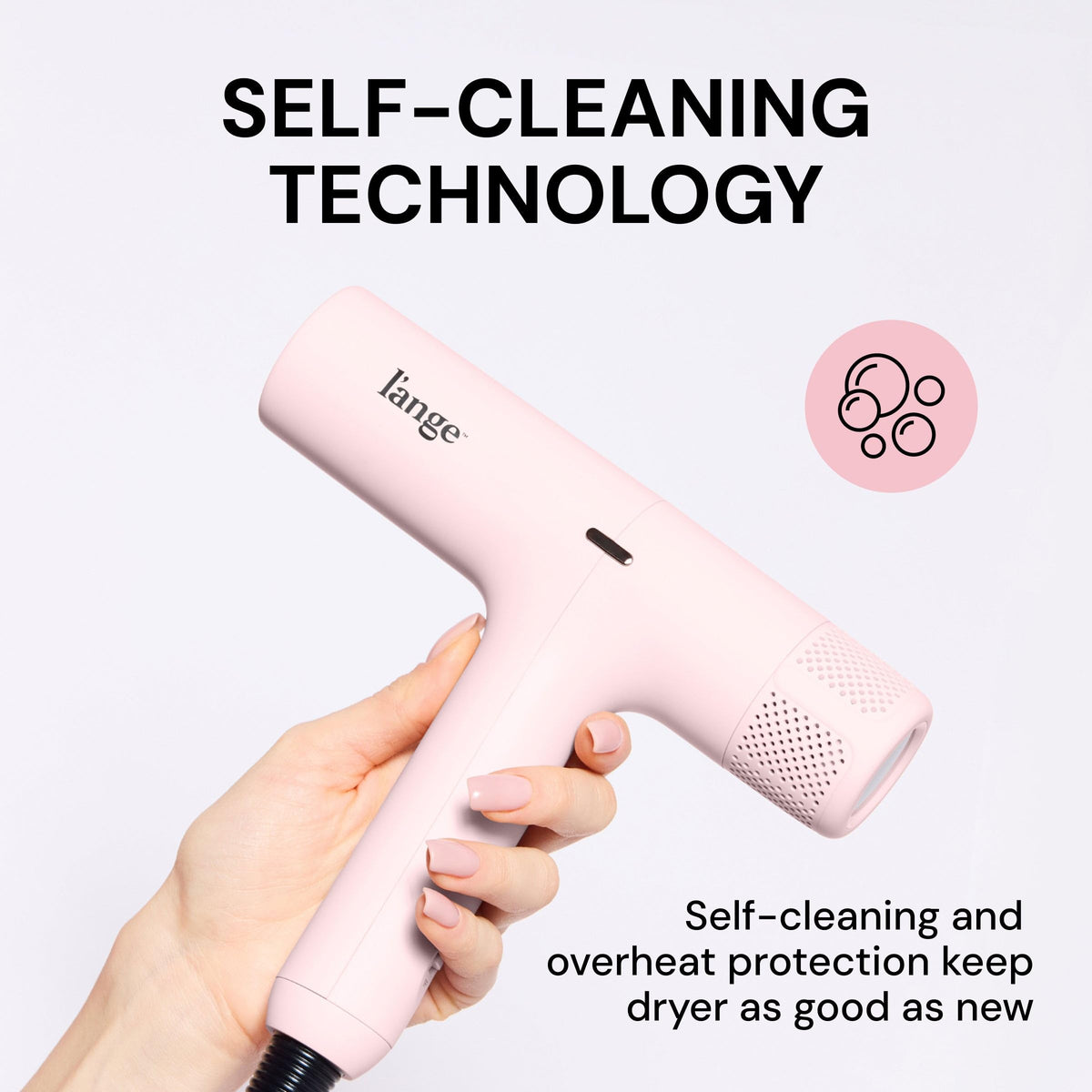 L'ANGE HAIR dryer held in hand to show scale and ultra-lightweight 1.14 lb benefit for easy use