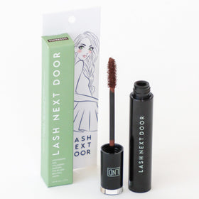 Lash Next Door tube next to pencil showing compact size and easy storage benefit