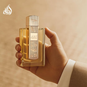 Lattafa Angham held in hand to show 100 ml size and real-world scale for purchase clarity