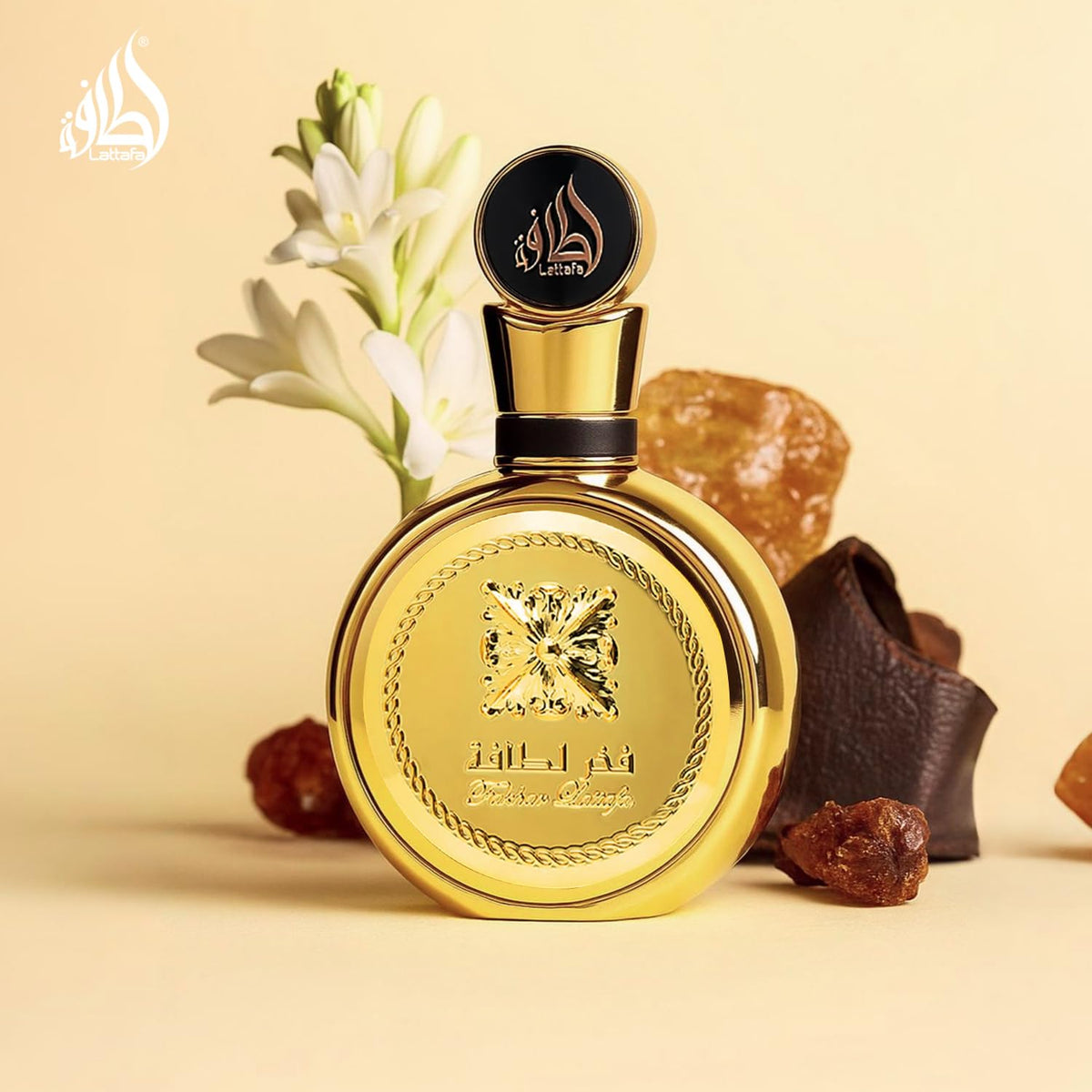 Lattafa Fakhar Gold bottle beside measuring scale indicating 100 ml extrait concentration
