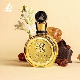 Lattafa Fakhar Gold bottle beside measuring scale indicating 100 ml extrait concentration
