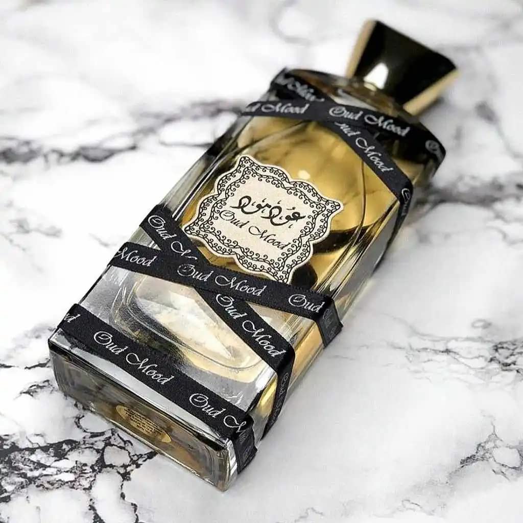 Lattafa Oud Mood fragrance drop close-up suggesting saffron and amber warmth