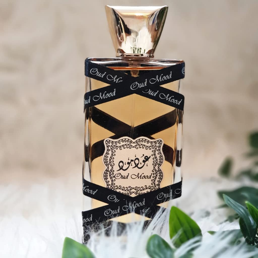 Lattafa Oud Mood next to a 3.4 oz scale object showing true size