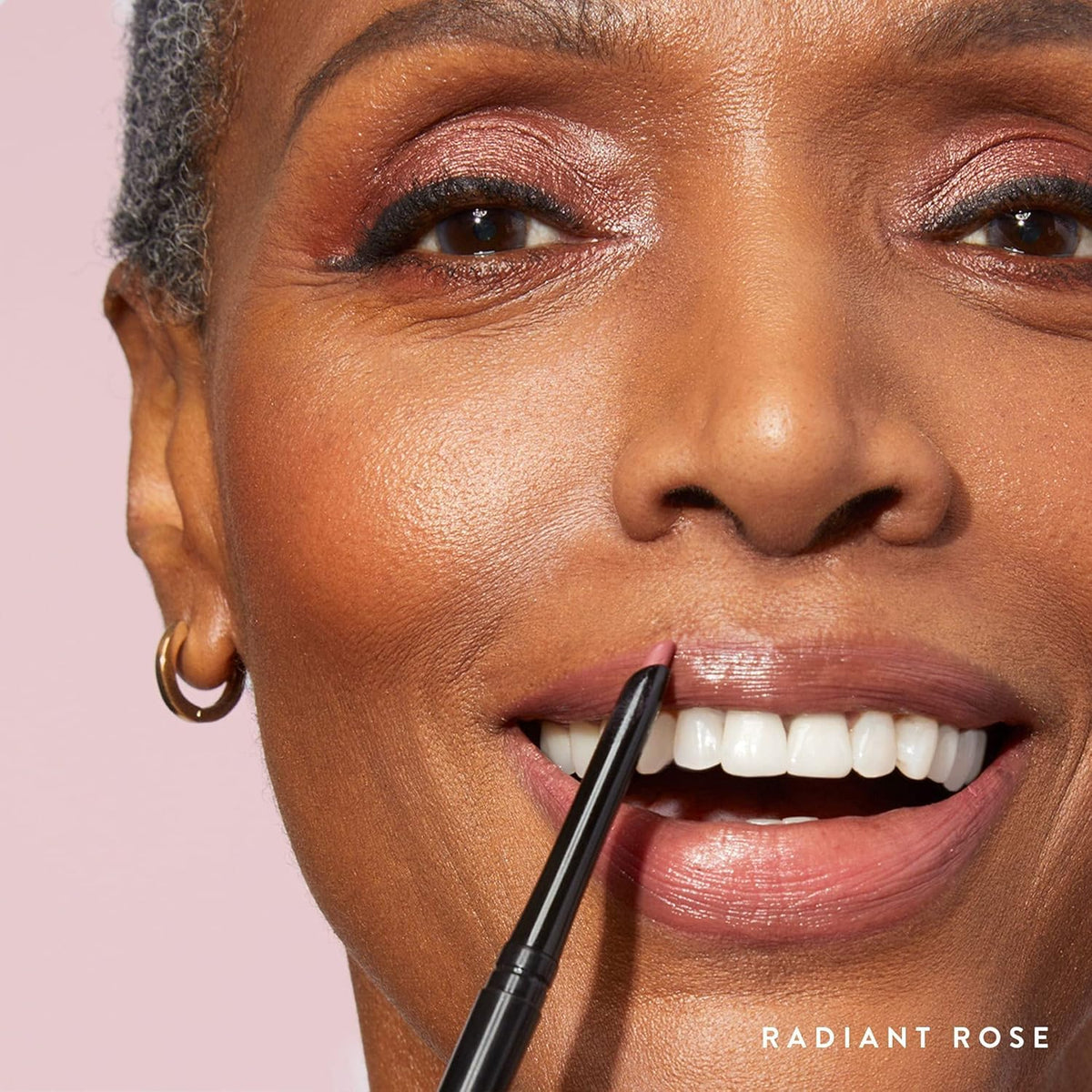 LAURA GELLER application on lips closeup illustrating defined lip edges and hydrated look