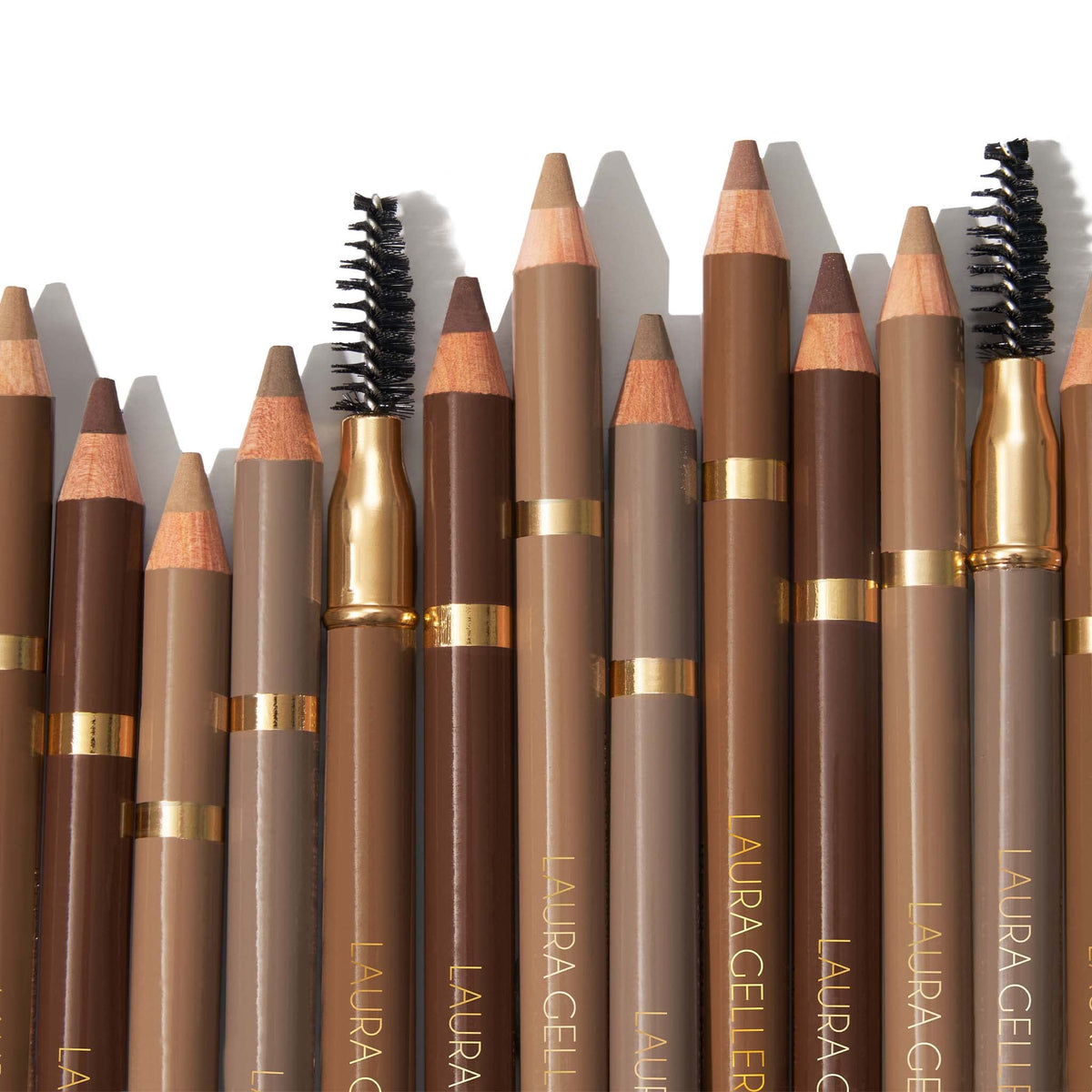 LAURA GELLER NEW YORK pencil held in hand to show compact size and control