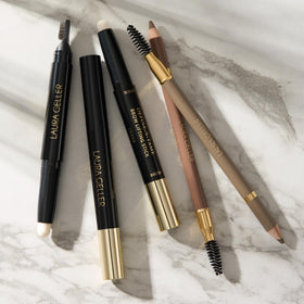 LAURA GELLER lifestyle shot of applying pencil for quick morning brow touch-up