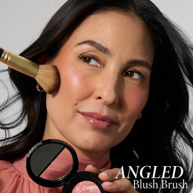 LAURA GELLER NEW YORK brush styled on vanity suggesting travel-ready convenience