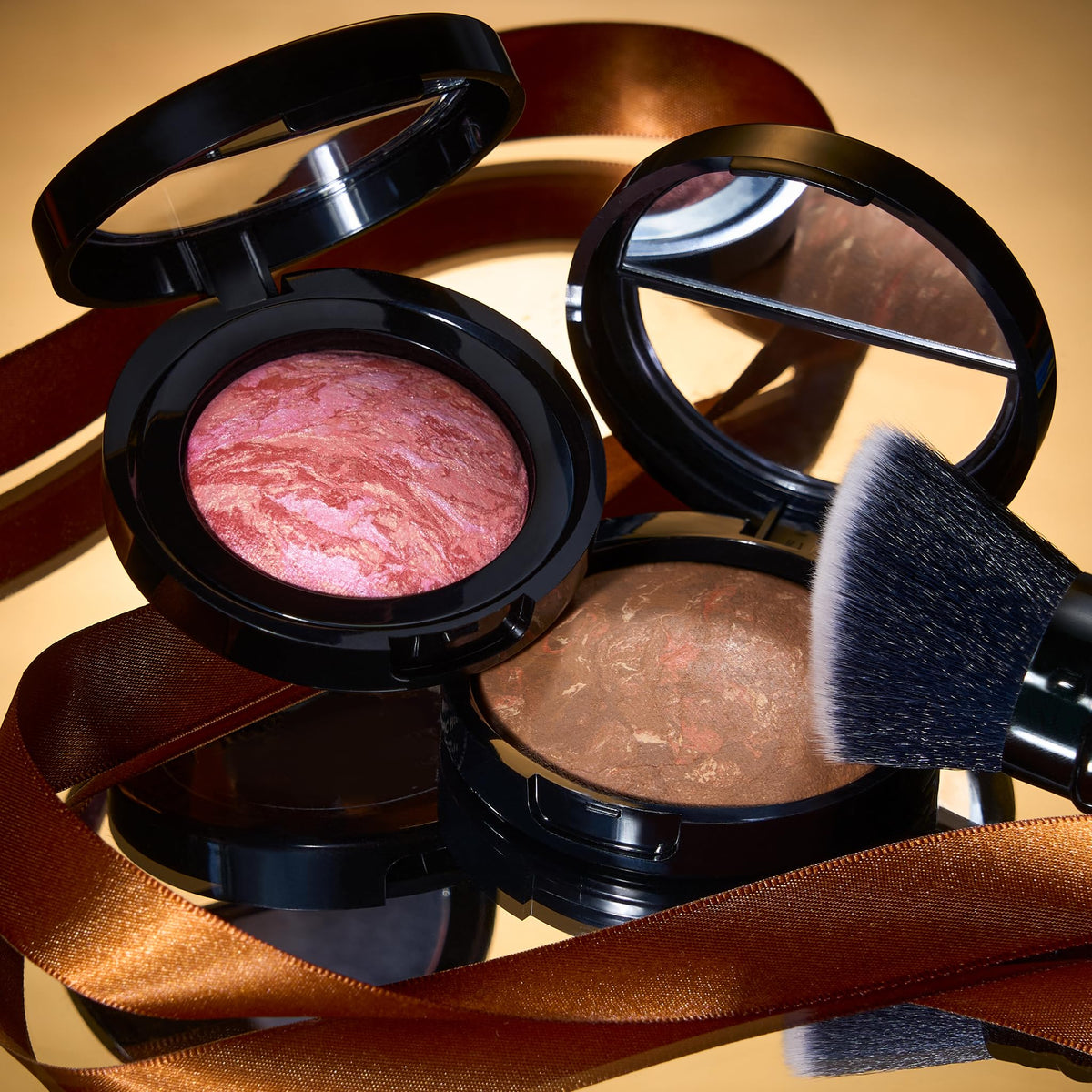 LAURA GELLER three-piece kit flatlay ideal for purse or travel touch-ups