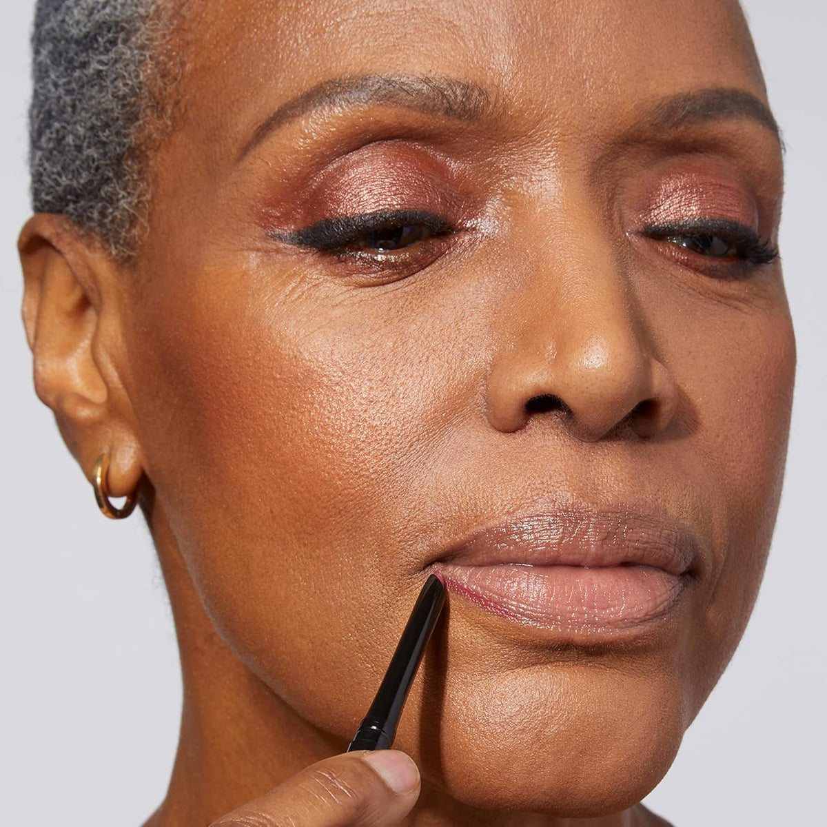 LAURA GELLER NEW YORK lip liner inside a makeup bag ready for on-the-go touchups