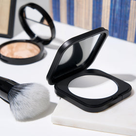 LAURA GELLER NEW YORK brush applying powder demonstrating easy oil control