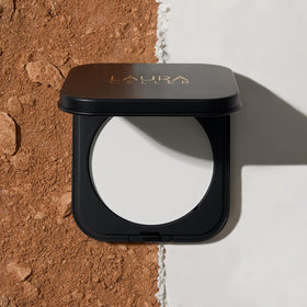 LAURA GELLER NEW YORK powder tucked inside a makeup bag for on-the-go touch-ups