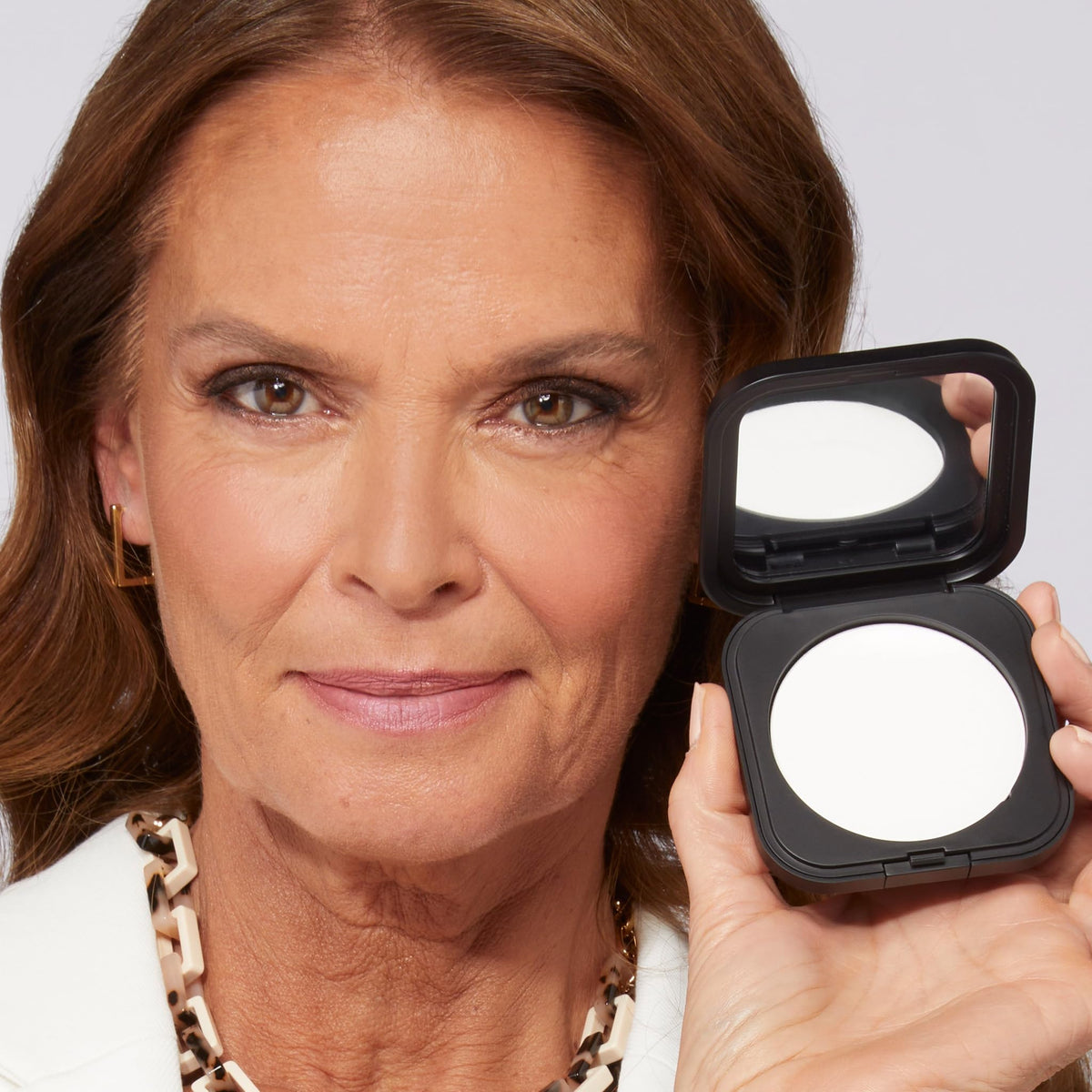 LAURA GELLER NEW YORK close-up of powder texture highlighting smooth application