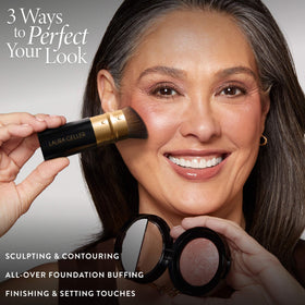 LAURA GELLER NEW YORK brush held in hand illustrating ergonomic scale and control