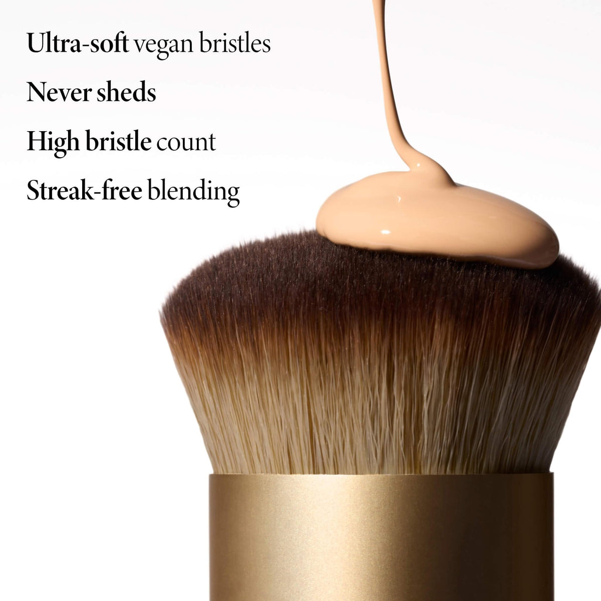 LAURA GELLER NEW YORK brush picking up liquid foundation for seamless blending