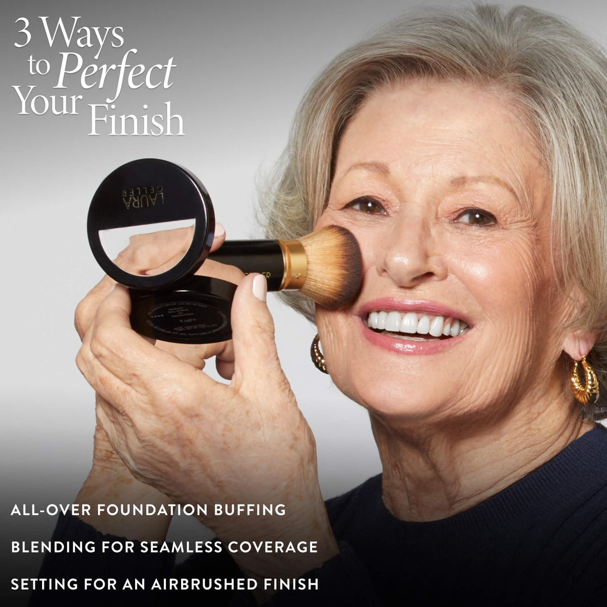 LAURA GELLER NEW YORK kabuki brush held in hand demonstrating compact scale and ease of use