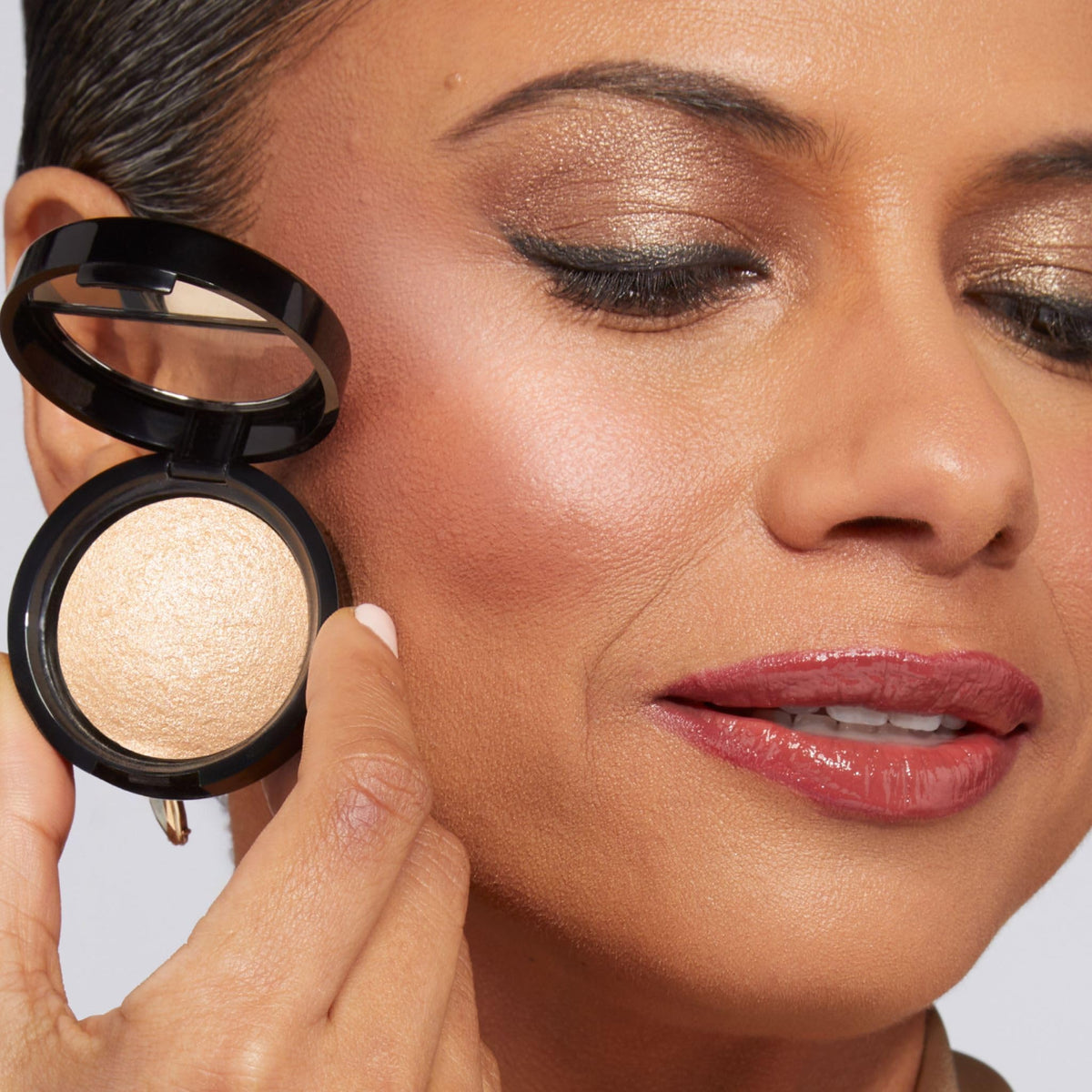 LAURA GELLER NEW YORK brush swatch across powder showing smooth payoff and buildable radiance